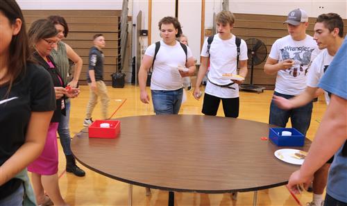 students play a game with high school principal 